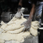 
              A worker prepares flour for bread inside a bakery in Lagos, Nigeria, on Friday, Feb. 3, 2023. Nearly a year after Russia invaded Ukraine the global economy is still enduring the consequences — crunched supplies of grain, fertilizer and energy along with more inflation and economic insecurity. One official in Nigeria said, “A lot of people have stopped eating bread; they have gone for alternatives because of the cost.’’ (AP Photo/Sunday Alamba)
            