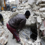 
              Syrian Civil Defense workers and security forces search through the wreckage of collapsed buildings, in Aleppo, Syria, Monday, Feb. 6, 2023. A powerful earthquake rocked wide swaths of Turkey and neighboring Syria on Monday, toppling hundreds of buildings and killing and injuring thousands of people. (AP Photo/Omar Sanadiki)
            