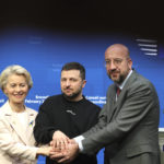 
              European Commission President Ursula von der Leyen, left, Ukraine's President Volodymyr Zelenskyy, center, and European Council President Charles Michel join hands after addressing a media conference at an EU summit in Brussels on Thursday, Feb. 9, 2023. European Union leaders are meeting for an EU summit to discuss Ukraine and migration. (AP Photo/Olivier Matthys)
            