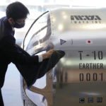 
              A staffer cleans a two-seater cabin that a startup company says is capable of rising to an altitude of 15 miles, which is roughly the middle of the stratosphere, during a news conference in Tokyo, Tuesday, Feb. 21, 2023. The Japanese startup company announced plans Tuesday to launch a commercial space viewing balloon flight that it hopes will bring down to earth an otherwise astronomically expensive experience. (AP Photo/Eugene Hoshiko)
            