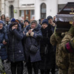 
              Relatives react as soldiers carry the coffin of Yevhen Zapotichnyi, a Ukrainian military servicemen who were killed in the east of the country, during his funeral in Lviv, Ukraine, Tuesday, Feb 7, 2023. (AP Photo/Emilio Morenatti)
            