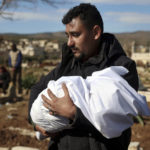 
              A man carries the body of a family member who died in a devastating earthquake that rocked Syria and Turkey at a cemetery in the town of Jinderis, Aleppo province, Syria, Tuesday, Feb. 7, 2023.  A newborn girl was found buried under debris with her umbilical cord still connected to her mother, Afraa Abu Hadiya, who was found dead, according to relatives and a doctor.  The baby was the only member of her family to survive from the building collapse Monday in  Jinderis, next to the Turkish border, Ramadan Sleiman, a relative, told The Associated Press.  (AP Photo/Ghaith Alsayed)
            
