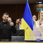 
              Ukraine's President Volodymyr Zelenskyy, left, gestures as European Parliament's President Roberta Metsola, right, applauds during an EU summit at the European Parliament in Brussels, Belgium, Thursday, Feb. 9, 2023. On Thursday, Zelenskyy will join EU leaders at a summit in Brussels, which German Chancellor Olaf Scholz described as a "signal of European solidarity and community." (AP Photo/Olivier Matthys)
            