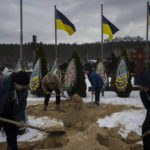 
              Undertakers bury the coffin of Eduard Strauss, a Ukrainian serviceman who died in combat on Jan. 17 in Bakhmut, during his funeral in Irpin, Ukraine, Monday, Feb. 6, 2023. (AP Photo/Daniel Cole)
            