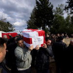 
              Men hold the coffins of Duygu Bolsoy Kalayci, rear, and her daughter Lavin Kalayci, Turkish Cypriot victims of the earthquake in Turkey, during a funeral procession in the Turkish occupied area in northeast coastal city of Famagusta, Cyprus, on Friday, Feb. 10, 2023. Duygu Bolsoy Kalayci and Lavin Kalayci, lost their lives in the earthquake in Adiyaman. (AP Photo/Petros Karadjias)
            