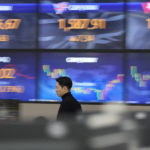 
              A currency trader walks by the screens showing the foreign exchange rates at a foreign exchange dealing room in Seoul, South Korea, Tuesday, Feb. 28, 2023. Shares climbed in Asia on Tuesday after Wall Street benchmarks clawed back some losses from their worst week since early December.(AP Photo/Lee Jin-man)
            