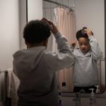 
              Akeim Smith, 10, brushes his hair as he and his sister Jari and mother Johnae ready for school and work Friday, Feb. 10, 2023, in Chicago. (AP Photo/Erin Hooley)
            