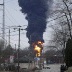 
              A black plume rises over East Palestine, Ohio, as a result of a controlled detonation of a portion of the derailed Norfolk and Southern Monday, Feb. 6, 2023. (AP Photo/Gene J. Puskar)
            