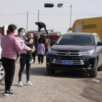 
              People gather at a checkpoint along a road leading to the site of a collapsed open pit mine in Alxa League in northern China's Inner Mongolia Autonomous Region, Thursday, Feb. 23, 2023. An open pit mine collapsed in China's northern Inner Mongolia region on Wednesday, killing multiple people and leaving dozens more missing, state media reported. (AP Photo/Ng Han Guan)
            