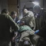 
              Medics give the first aid to a wounded Ukrainian soldier near Bakhmut, the site of the heaviest battles with the Russian troops, Donetsk region, Ukraine, Monday, Feb. 27, 2023. (AP Photo/Yevhen Titov)
            