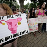 
              FILE - Abortion-rights advocates gather outside a the Kansas Statehouse to protest the U.S. Supreme Court's ruling on abortion, June 24, 2022, in Topeka, Kan. The Republican-controlled Kansas Legislature is considering millions of dollars in state funds for centers that provide pregnancy tests, sonograms and counseling in an effort to keep women from having abortions. Also on the table: millions more in income tax credits to their donors. (AP Photo/Charlie Riedel, File)
            