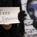 
              A woman holds a banner that reads: "Freedom of Navalny" during a rally in support of Russia's political prisoners in Belgrade, Serbia, Saturday, Jan. 21, 2023. A friendly, fellow-Slavic nation, Serbia has welcomed the fleeing Russians who need visas to travel to much richer Western European states. But in Serbia, they have not escaped the long reach of Putin's hardline regime influence. (AP Photo/Darko Vojinovic)
            