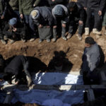 
              Mourners bury family members who died in a devastating earthquake that rocked Syria and Turkey at a cemetery in the town of Jinderis, Aleppo province, Syria, Tuesday, Feb. 7, 2023.  A newborn girl was found buried under debris with her umbilical cord still connected to her mother, Afraa Abu Hadiya, who was found dead, according to relatives and a doctor.  The baby was the only member of her family to survive from the building collapse Monday in  Jinderis, next to the Turkish border, Ramadan Sleiman, a relative, told The Associated Press. (AP Photo/Ghaith Alsayed)
            
