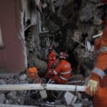 
              Members of the British rescue team search in a destroyed house in Antakya, southern Turkey, Thursday, Feb. 9, 2023. Rescue workers made a final push Thursday to find survivors of the catastrophic earthquake in Turkey and Syria that rendered many communities unrecognizable to their inhabitants. (AP Photo/Khalil Hamra)
            