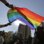 
              FILE - Activists from the Lesbian, Gay, Bisexual, and Transgender (LGBTQ) community in Lebanon shout slogans and hold up a rainbow flags as they march calling on the government for more rights in the country gripped by economic and financial crisis during ongoing protests, in Beirut, Lebanon, June 27, 2020. Security agencies and government officials across several countries in the Middle East and North Africa have been using social media platforms and mobile dating apps to track and crack down on LGBTQ people, international rights group Human Rights Watch said Tuesday, Feb. 21, 2023. (AP Photo/Hassan Ammar, File)
            