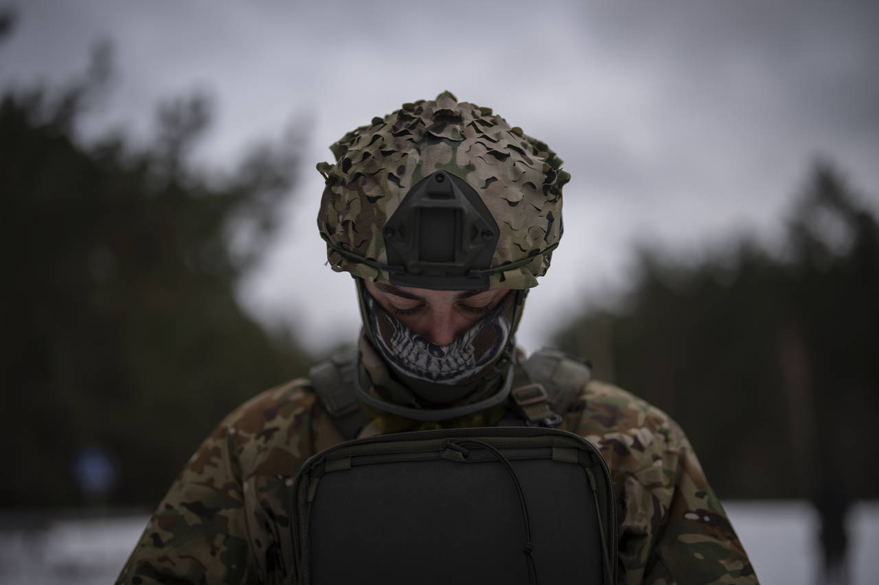 A Ukrainian serviceman controls a drone during a demonstration close to the border with Belarus, Uk...
