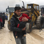 
              A man carries the body of an earthquake victim in the Besnia village near the Turkish border, Idlib province, Syria, Monday, Feb. 6, 2023. A powerful earthquake has caused significant damage in southeast Turkey and Syria and many casualties are feared. Damage was reported across several Turkish provinces, and rescue teams were being sent from around the country. (AP Photo/Ghaith Alsayed)
            