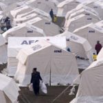 
              People with their belongings arrive at the tents, in Kharamanmaras, southeastern Turkey, Friday, Feb 10, 2023. Rescuers pulled several people alive from the shattered remnants of buildings on Friday, some who survived more than 100 hours trapped under crushed concrete in the bitter cold after a catastrophic earthquake slammed Turkey and Syria. (AP Photo/Kamran Jebreili)
            