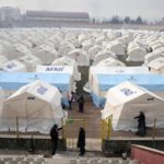 
              People arrive at the tents that were setup to accommodate earthquake survivors, in Kharamanmaras, southeastern Turkey, Friday, Feb. 10, 2023. Rescuers pulled several people alive from the shattered remnants of buildings on Friday, some who survived more than 100 hours trapped under crushed concrete in the bitter cold after a catastrophic earthquake slammed Turkey and Syria. (AP Photo/Kamran Jebreili)
            