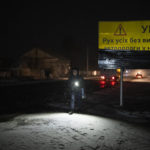 
              A woman walks with a torch in the village of Kolychivka, Ukraine, Wednesday, Feb. 1, 2023. (AP Photo/Daniel Cole)
            