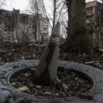 
              A part of a rocket sticks from a ground in front of a residential building which was heavily bombed by Russian forces in the frontline city of Vuhledar, Ukraine, Saturday, Feb. 25, 2023. (AP Photo/Evgeniy Maloletka)
            