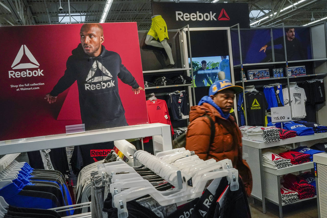 A man walks past a Reebok display at the Walmart Supercenter in North Bergen, N.J., on Thursday, Fe...