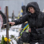 
              Nataliya cries at the grave of her brother Oleg Kunynets, a Ukrainian military servicemen who were killed in the east of the country, during his funeral in Lviv, Ukraine, Tuesday, Feb 7, 2023. (AP Photo/Emilio Morenatti)
            