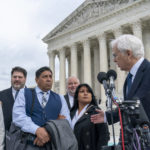 
              Attorney Eric Schnapper, right, gestures to Beatriz Gonzalez, second from right, the mother of 23-year-old Nohemi Gonzalez, a student killed in the Paris terrorist attacks, and stepfather Jose Hernandez, front row center, speak outside the Supreme Court,Tuesday, Feb. 21, 2023, in Washington. A lawsuit against YouTube from the family of Nohemi Gonzalez was argued at the Supreme Court. (AP Photo/Alex Brandon)
            
