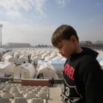 
              A child walks at a stadium where tents have been setup to accommodate earthquake survivors, in Kharamanmaras, southeastern Turkey, Friday, Feb. 10, 2023. Rescuers pulled several people alive from the shattered remnants of buildings on Friday, some who survived more than 100 hours trapped under crushed concrete in the bitter cold after a catastrophic earthquake slammed Turkey and Syria. (AP Photo/Kamran Jebreili)
            
