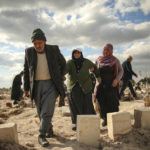 
              People at the cemetery as they bury their loved ones, victims of Monday earthquake, in Adiyaman, Turkey, Friday, Feb. 10, 2023. Emergency crews made a series of dramatic rescues in Turkey on Friday, pulling several people, some almost unscathed, from the rubble, four days after a catastrophic earthquake killed more than 20,000.(AP Photo/Emrah Gurel)
            