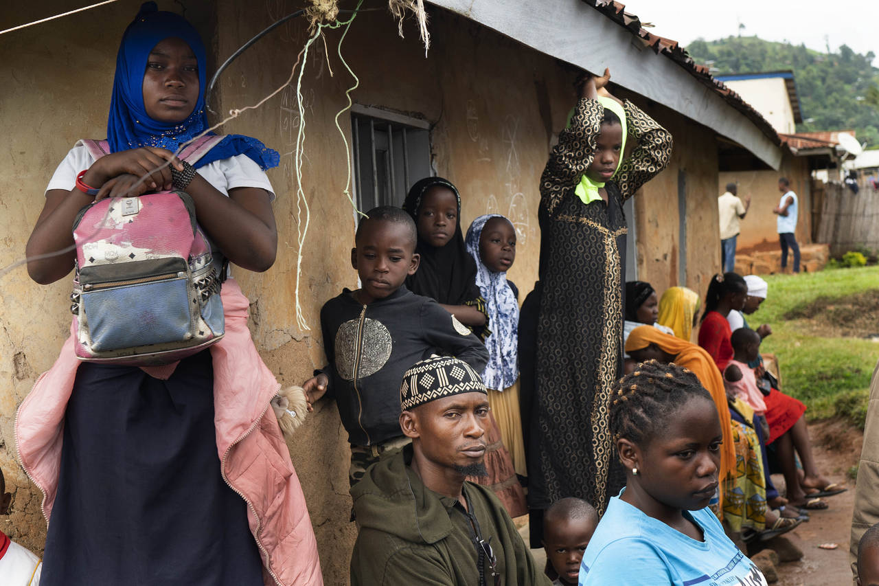 FILE - Residents wait in line to receive the Ebola vaccine in Beni, Congo DRC on July 13, 2019. A c...