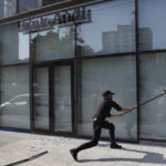 
              FILE - An anti-government protester destroys a bank window during a protest against the deepening financial crisis, in Beirut, on April 28, 2020. Angry protesters in Lebanon Thursday Feb. 16, 2023 smashed windows and set tires on fire outside two of the country's biggest banks in the capital city, as the value of the local currency hit a new low and poverty deepens. (AP Photo/Hussein Malla, File)
            