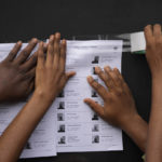
              Electoral workers display on the wall a voters' registration list at a polling station in Lagos, Nigeria, Saturday, Feb. 25, 2023. Voters in Africa's most populous nation are heading to the polls Saturday to choose a new president, following the second and final term of incumbent Muhammadu Buhari. (AP Photo/Ben Curtis)
            