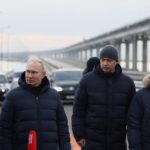 
              Russian President Vladimir Putin, second left, listens to Deputy Prime Minister Marat Khusnullin, left, as he visits the Crimean Bridge connecting Russian mainland and the Crimean Peninsula over the Kerch Strait on Monday, Dec. 5, 2022. The bridge was damaged by a truck bomb in October in an attack that Russia blamed on Ukraine. Putin sent Russian troops into Ukraine on Feb. 24, 2022, appears determined to prevail. (Mikhail Metzel, Sputnik, Kremlin Pool Photo via AP, File)
            