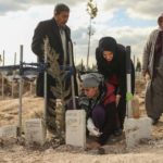 
              People at the cemetery as they bury their loved ones, victims of Monday earthquake, in Adiyaman, Turkey, Friday, Feb. 10, 2023. Emergency crews made a series of dramatic rescues in Turkey on Friday, pulling several people, some almost unscathed, from the rubble, four days after a catastrophic earthquake killed more than 20,000.(AP Photo/Emrah Gurel)
            