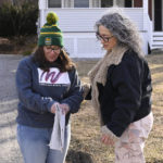 
              Winsted Citizen subscriber Ruthie Ursone Napoleone, left, opens the first edition of The Winsted Citizen, looking for her father's obituary as reporter Michelle Manafy, right, looks on, Friday, Feb. 3, 2023, in Winsted, Conn. Ursone Napoleone had several connections to the first issue, her workplace and nephew were featured in two separate stories and her father's obituary is in the paper. She stopped Manafy who was delivering papers to ask her if she could have extra copies and said, "I wish my father could read this." At a time that local newspapers are dying at an alarming rate, longtime activist Ralph Nader is helping give birth to one. Nader put up $15,000 to help launch the Winsted Citizen and hired a veteran Connecticut journalist, Andy Thibault, to put it together. (AP Photo/Jessica Hill)
            