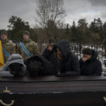
              Relatives stand by the coffin of Eduard Strauss, a Ukrainian serviceman who died in combat on Jan. 17 in Bakhmut, during his funeral in Irpin, Ukraine, Monday, Feb. 6, 2023. (AP Photo/Daniel Cole)
            