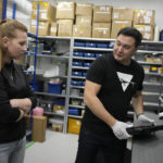 
              Founder and CEO of the drone manufacturer Atlas Aerospace, Ivan Tolchinksy, right, talks with order picker Marya Zgeryu in the capital Riga, Latvia, Wednesday, Feb. 1, 2023. Since Russia invaded Ukraine last February, Lithuania, Latvia and Estonia — three states on NATO’s eastern flank scarred by decades of Soviet-era occupation — have been among the top donors to Kyiv. (AP Photo/Sergei Grits)
            