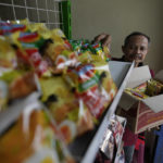 
              Mukroni, 52, places instant noodles on a shelf at his store in Bekasi, on the outskirts of Jakarta, Indonesia, Thursday, Feb 2, 2023. Nearly a year after Russia invaded Ukraine, punishingly high food prices are inflicting particular hardship on the world’s poor. Customers, Mukroni said, “will not come to the shop’’ if prices are too high. (AP Photo/Achmad Ibrahim)
            