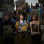 
              People shout slogans during a protest by pro-Ukraine people against Russia's invasion of Ukraine, in Istanbul, Turkey, Friday, Feb. 24, 2023. A wrecked Russian tank put on display in Berlin, a bloody cake with a skull on top of it left in a Belgrade street and Ukraine's yellow-and-blue flag held aloft in the sizzling Bangkok sun were among the memorials, stunts and ceremonies held across the world Friday to mark the anniversary of Moscow's full-scale invasion of its neighbour. (AP Photo/Francisco Seco)
            