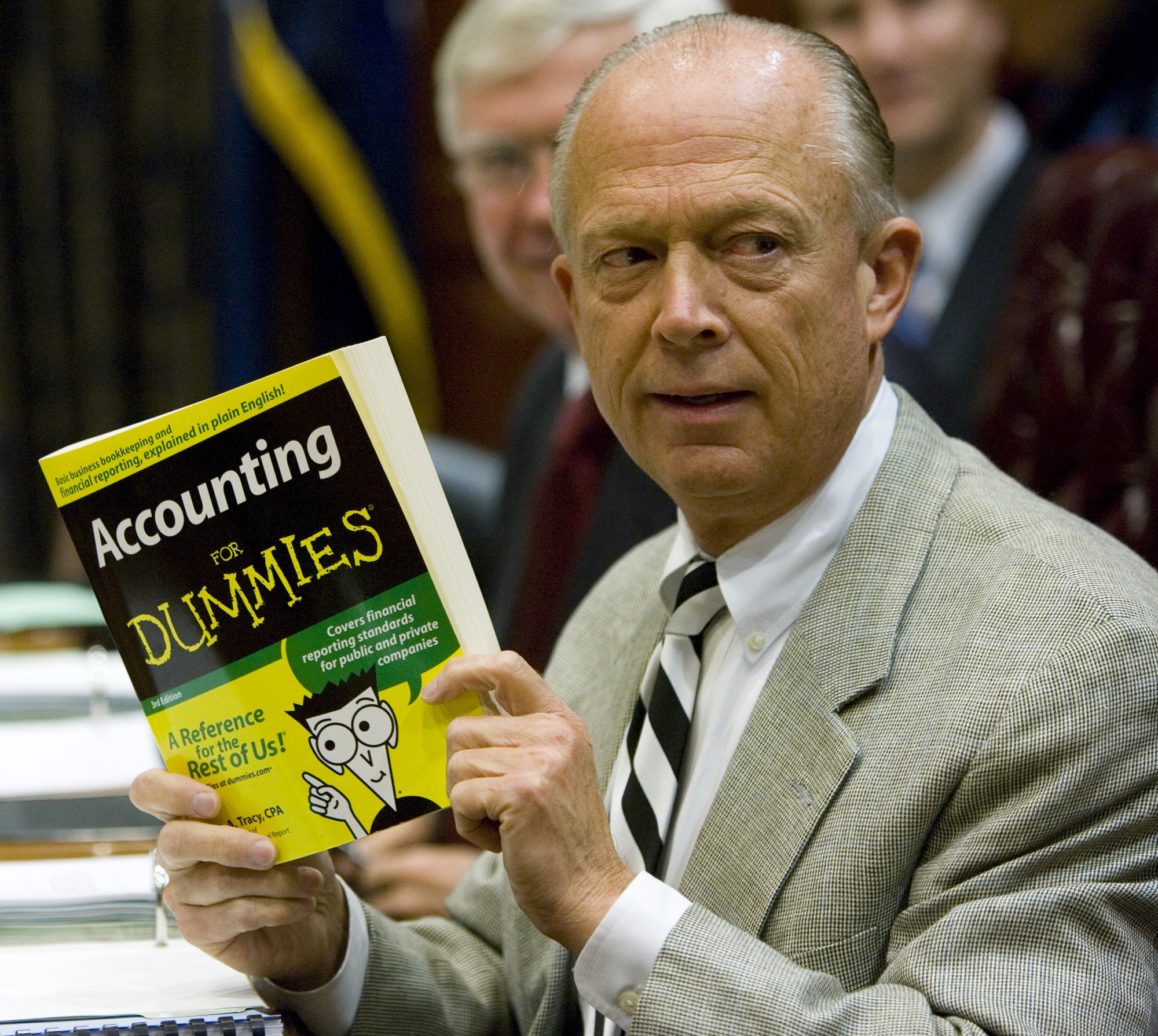FILE - South Carolina Comptroller General Richard Eckstrom holds up a book he wanted to present to ...