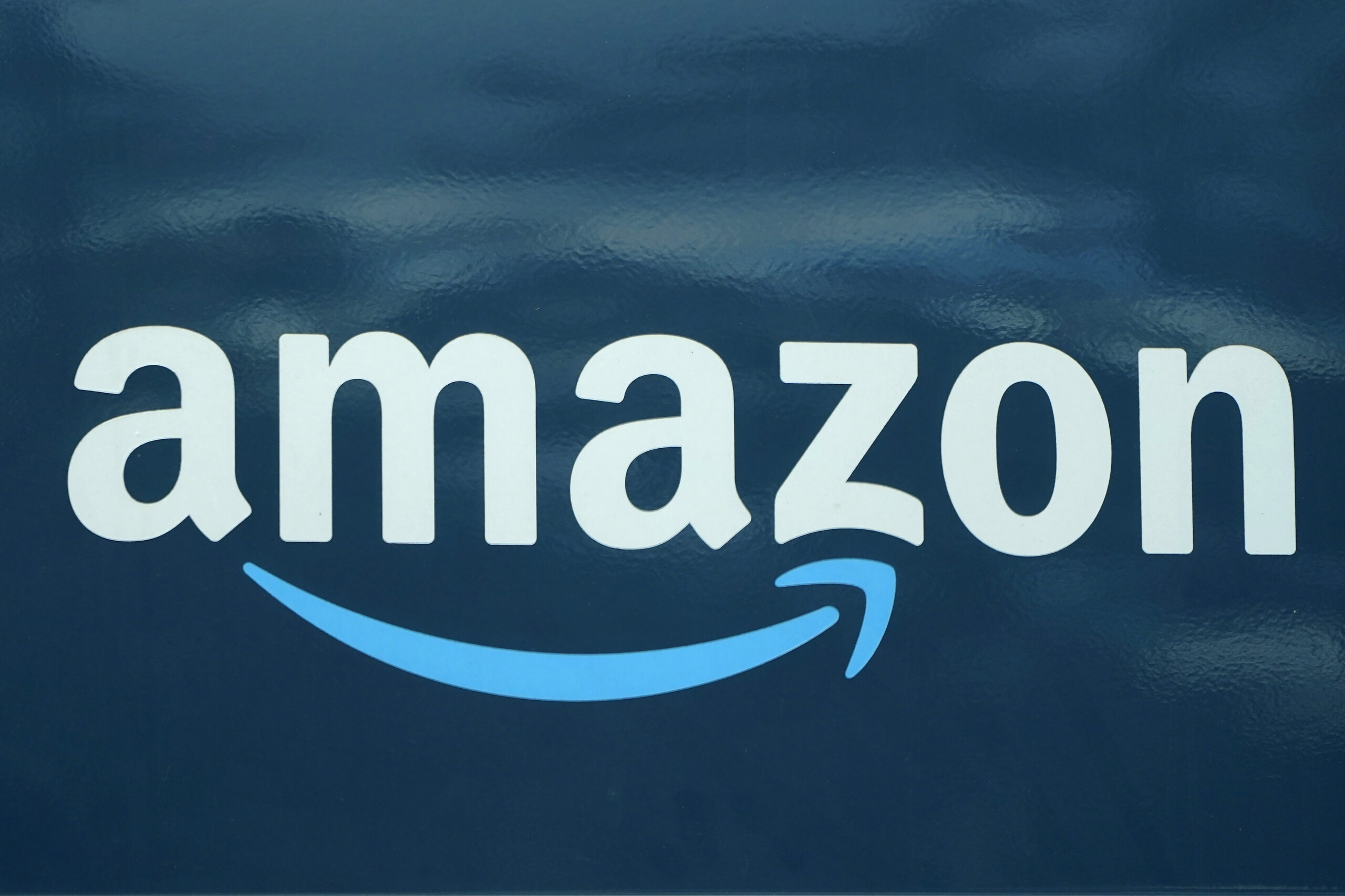 FILE - An Amazon logo appears on a delivery van, Oct. 1, 2020, in Boston. Amazon is pausing constru...
