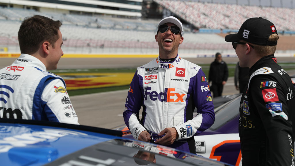 Denny Hamlin, center,  shares a laugh with Christopher Bell, left, and Ty Gibbs, on the grid during...