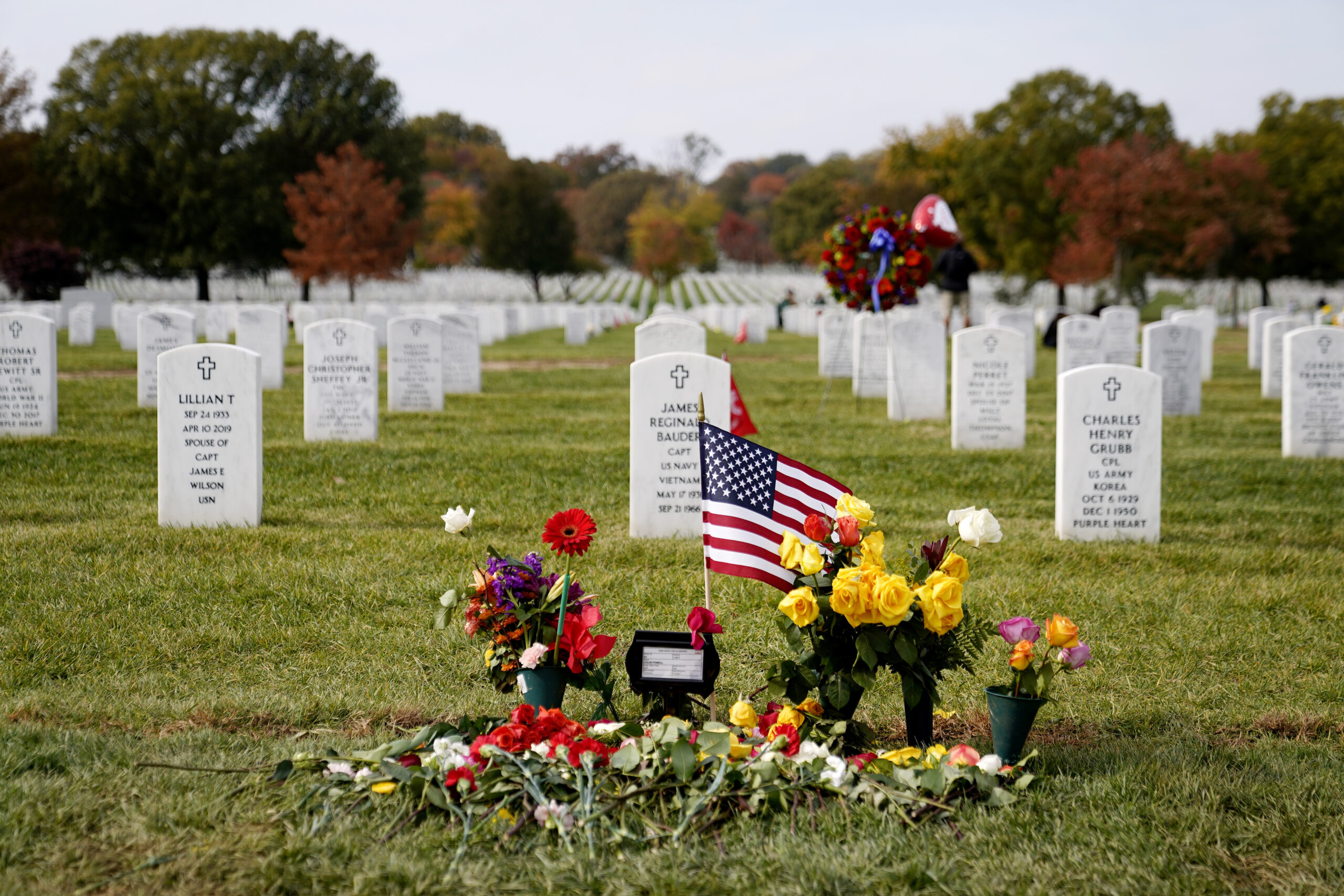 FILE - Flowers rest at the burial plot of former Secretary of State Colin Powell in Section 60 at A...