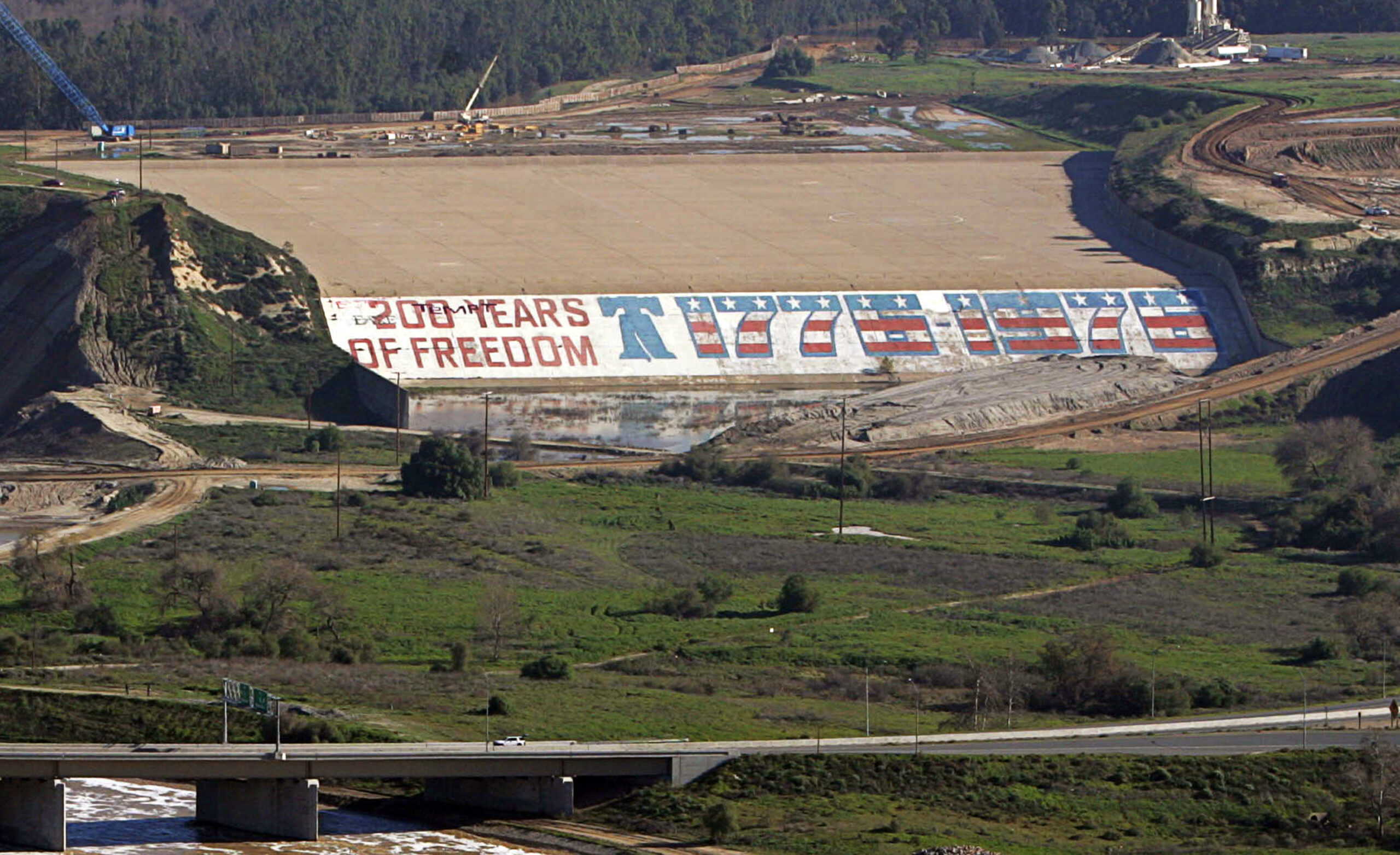 FILE - Seen is the Prado Dam with its bicentennial mural at a time when crews were working to close...