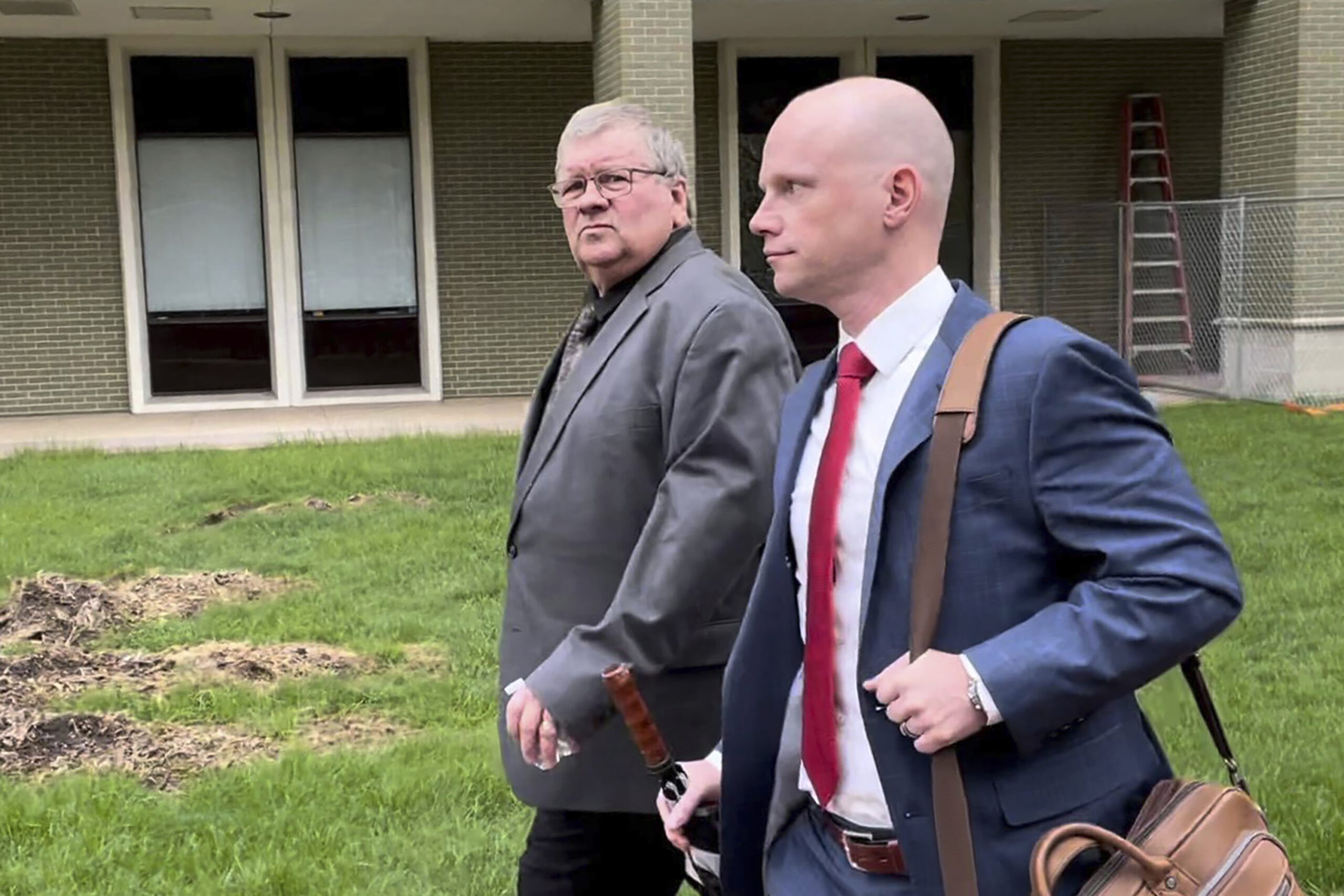 The former head of a Michigan marijuana licensing board Rick Johnson, left, walks with his attorney...