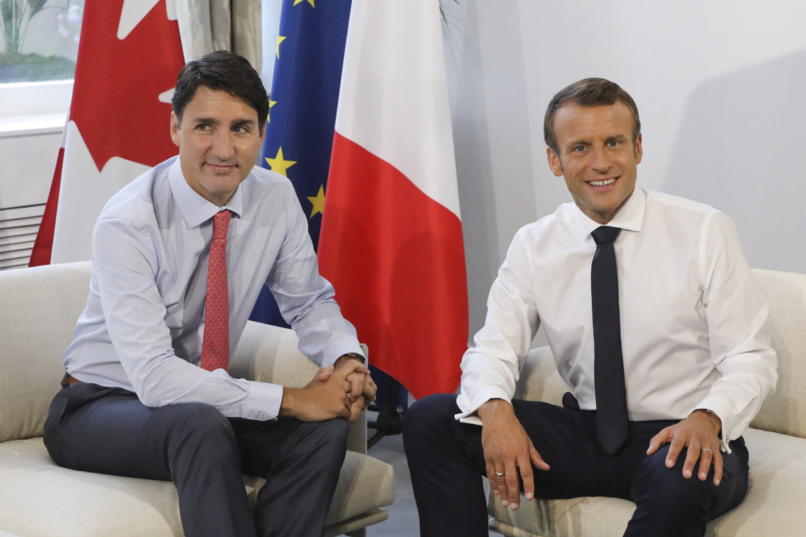 FILE - Canadian Prime Minister Justin Trudeau, left, poses with French President Emmanuel Macron du...