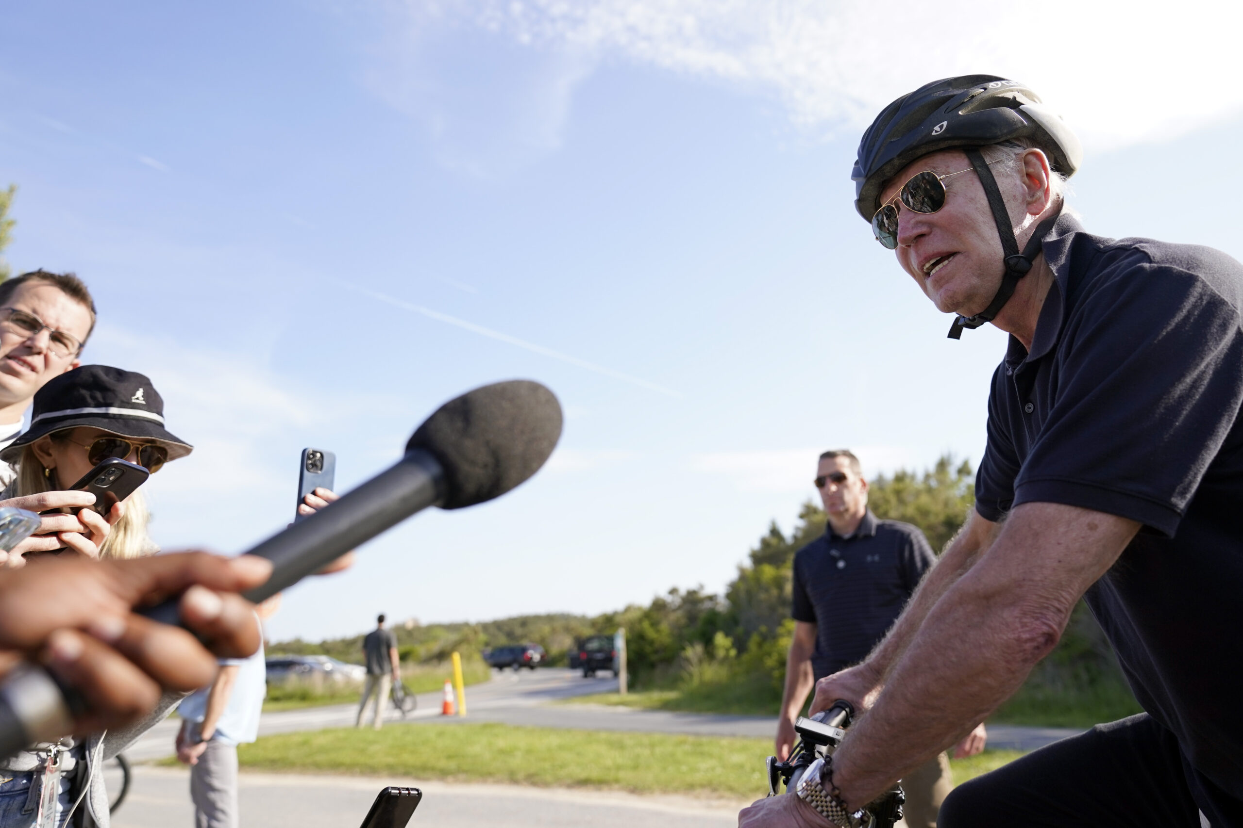 President Joe Biden speaks to members of the media as he goes on a bike ride in Gordons Pond State ...