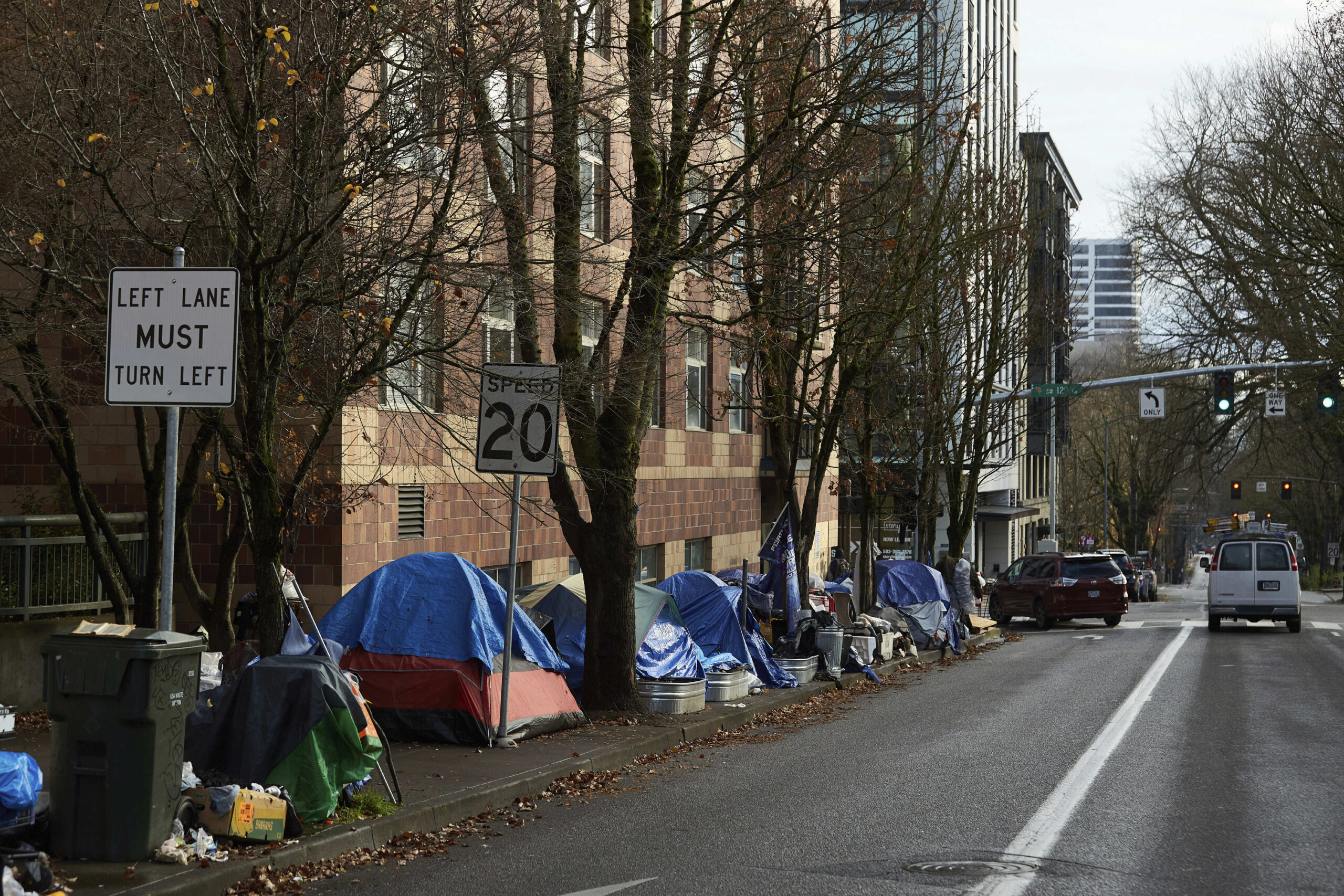 FILE - Tents line the sidewalk on SW Clay St in Portland, Ore., on Dec. 9, 2020. Portland Mayor Ted...