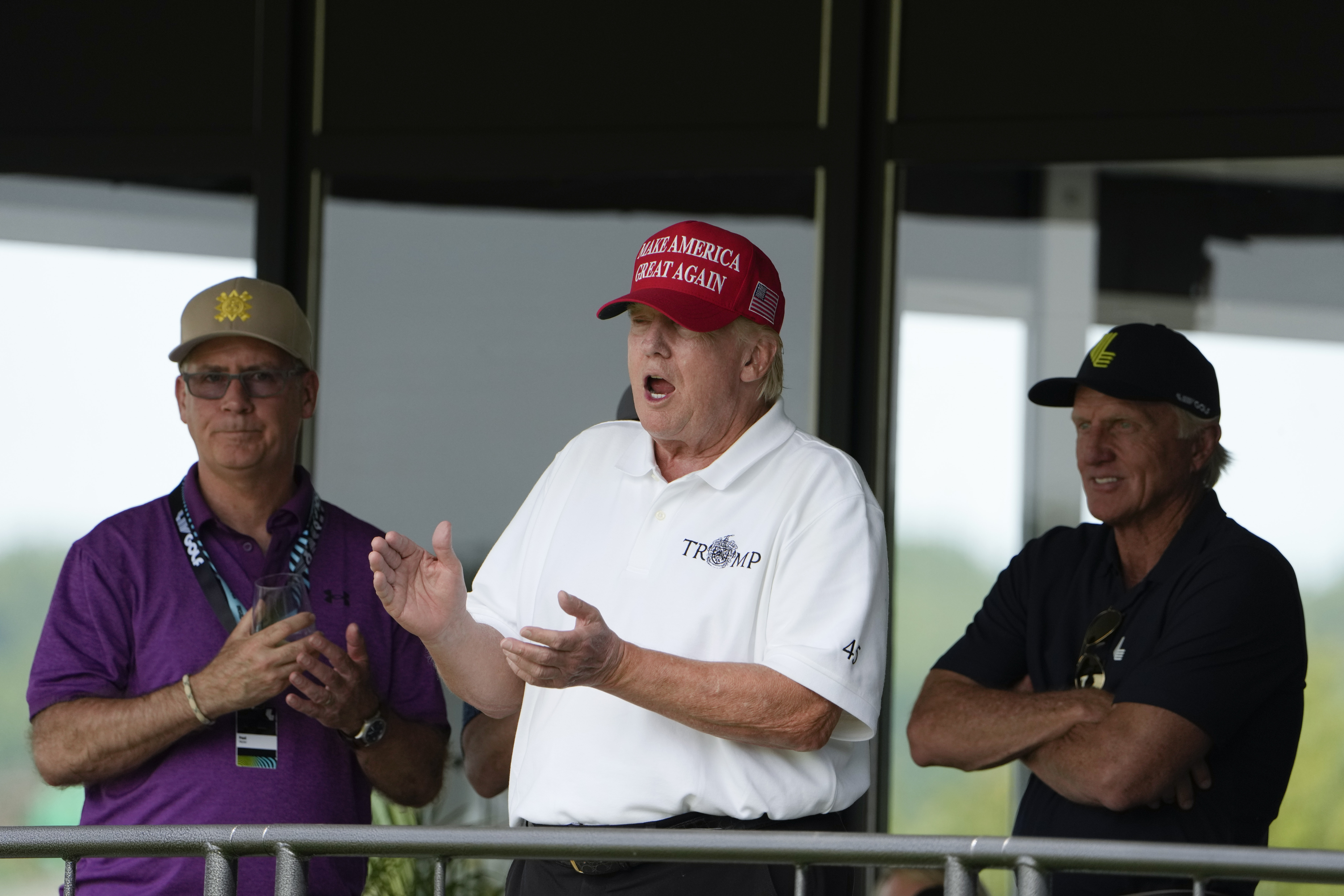 Former President Donald Trump, Greg Norman, LIV Golf CEO, right, and Paul Myler, deputy head of mis...